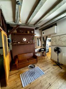 a living room with a couch and a table at T2 L'Atypique au pied de la cathédrale in Bourges