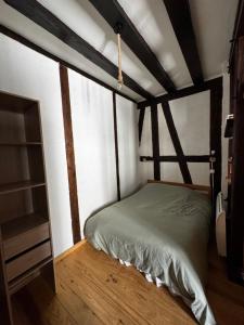 a bedroom with a bed and a book shelf at T2 L'Atypique au pied de la cathédrale in Bourges