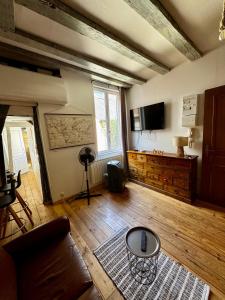 a living room with a couch and a table at T2 L'Atypique au pied de la cathédrale in Bourges