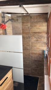 a kitchen with wooden walls and a white counter top at T2 L'Atypique au pied de la cathédrale in Bourges +5 photos