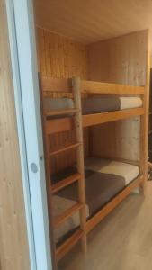 a bunk bed with several shelves in a room at Evasion in Orcières