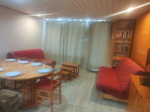 a dining room with a table and red chairs at Evasion in Orcières