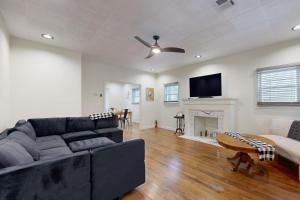 a living room with a couch and a tv at Easy Access to OSU! 'Marvin's Manor' in Stillwater in Stillwater
