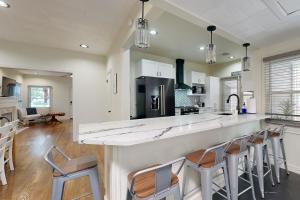 a kitchen with a large counter with stools at Easy Access to OSU! 'Marvin's Manor' in Stillwater in Stillwater +18 photos
