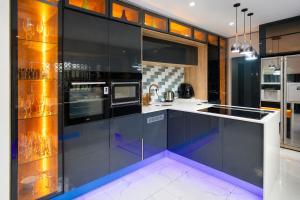 a kitchen with black cabinets and a stove at Kumnandi Modern Suite in Beacon Bay