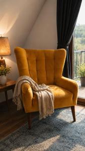 a yellow couch in a living room with a window at SKALNA CHATA 150 m do Term, Basen in Białka Tatrzańska