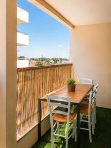 a table and chairs on a balcony with a view at Résidence de Noëlle in Canet-en-Roussillon