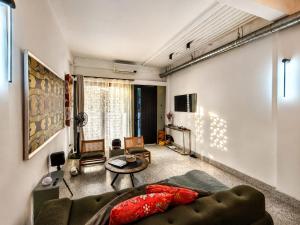 a living room with a couch and a table at Siri Designer 3-Storey Townhouse with Garden and Luxury Amenities in Bangkok