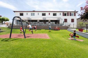 a group of people playing on a playground at Hotel Restaurant Pecoitz in Saint-Jean-Pied-de-Port