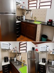 a kitchen with a stainless steel refrigerator and a sink at Pousadas JC 1 AP completo in Santarém