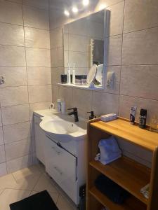 a bathroom with a sink and a mirror at Zielona Dolinka in Kostrzyca +15 photos