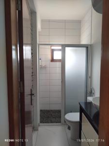 a bathroom with a toilet and a sink at Kasa Tabuga in Porto Novo