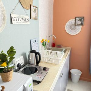 a kitchen with a counter with a microwave and a sink at The Italian Studio7 in Dammam