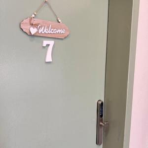 a door with a sign that says welcome on it at The Italian Studio7 in Dammam +32 photos
