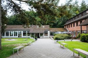 a row of benches in front of a building at Der Sunderhof in Seevetal