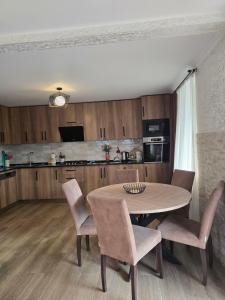 a kitchen with a table and chairs in a room at Guest House KATO in Poti +4 photos