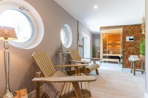 a living room with two chairs and a table at Püppi Hems Huus in Osterhever +27 photos