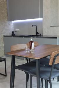 a wooden table with two glasses on top of it at Sunny Home in Gandzakʼar +7 photos