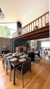 a dining room with a table and chairs and a staircase at Villa Romeo in Oviedo