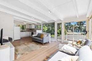 a living room with a couch and a kitchen at The Loft at Long Beach in Long Beach