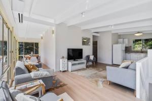 a living room with two couches and a tv at The Loft at Long Beach in Long Beach