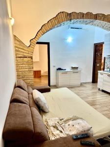 a living room with a couch and a brick wall at Casale di Torvaianica in Campo Iemini