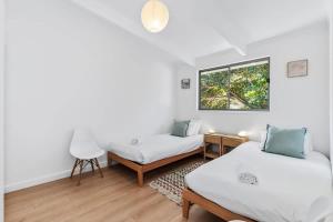 a room with two beds and a window at The Loft at Long Beach in Long Beach