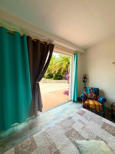 a bedroom with a window with a view of a yard at Chambre d'hôtes in Ondara +19 photos
