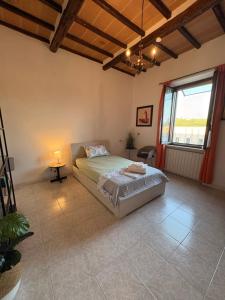 a bedroom with a bed and a large window at Aperto Tuscany apartment in Torrenieri