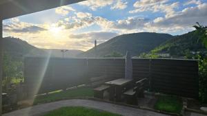 a bench on a balcony with a view of mountains at Pfälzerblick Lambrecht- Ferienwohnung mit Garten in Lambrecht
