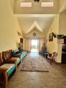 a living room with couches and a rug at Candy Ville Resorts in Coonoor