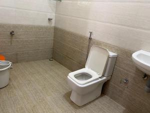 a bathroom with a toilet and a sink at Candy Ville Resorts in Coonoor +55 photos