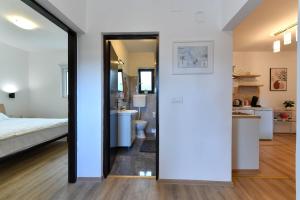 a bedroom with a bed and a bathroom at Guesthouse Spektar in Irinovac +51 photos