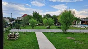a garden with a path and trees and a house at Фазенда "Змерега" in Solotvyno