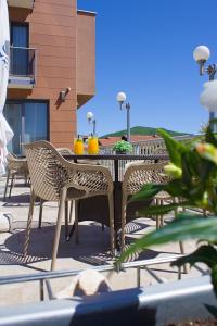 a table and chairs on a patio with drinks on it at Hotel Luna in Međugorje