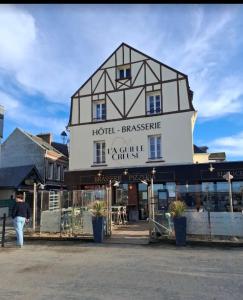 a man walking in front of a building at L'Aiguille Creuse in Étretat