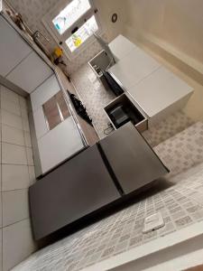 an overhead view of a kitchen with stainless steel appliances at Appartement Bizerte Nord in Bizerte +2 photos