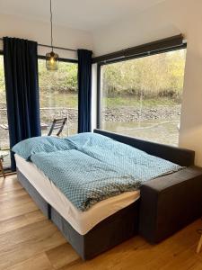 a bedroom with a bed in front of a window at Hausboot Stöckte in Winsen