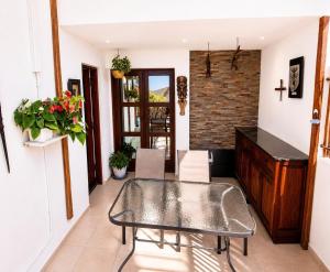 a room with a table and chairs and a brick wall at Casa Mangrove in Maputo