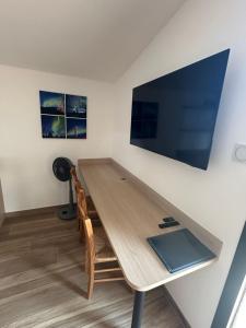 a wooden table with a laptop on top of it at Appartement SUOMI in Saint-Sorlin-en-Bugey