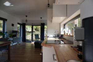 a kitchen with white cabinets and a counter top at Hausboot Stöckte in Winsen