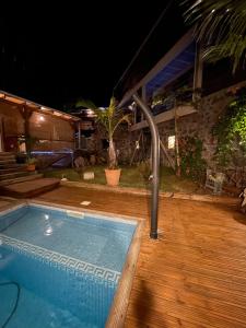a swimming pool in front of a house at night at L'Escale Cosy in Saint-Paul