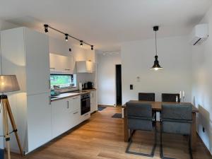 a kitchen and dining room with a table and chairs at Hausboot Stöckte in Winsen +27 photos