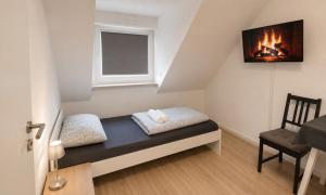 a small room with a bench and a window at 92 City Rooms in Koblenz +14 photos
