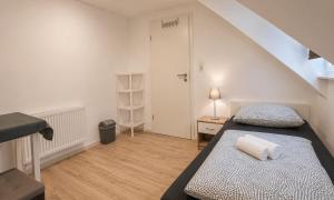 a bedroom with a bed and a stair case at 92 City Rooms in Koblenz