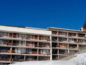 an apartment building with balconies in the snow at Evasion in Orcières +2 photos