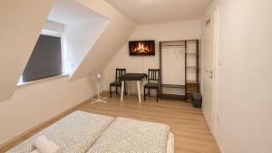 a living room with a bed and a table with chairs at 92 City Rooms in Koblenz