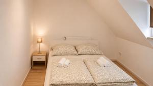 a bedroom with a bed with two pillows on it at 92 City Rooms in Koblenz