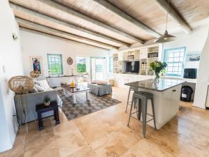a kitchen and living room with a couch and a table at Rose Pearl in Paternoster