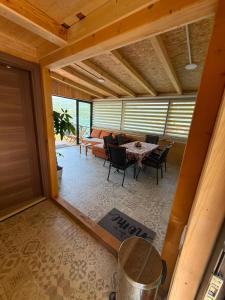 a living room with a table and a couch at Splav Astra Perućac in Perućac